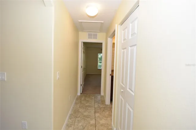 a view of a hallway with wooden shelves