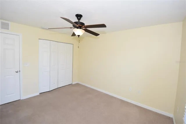 a bathroom with a granite countertop toilet sink and mirror