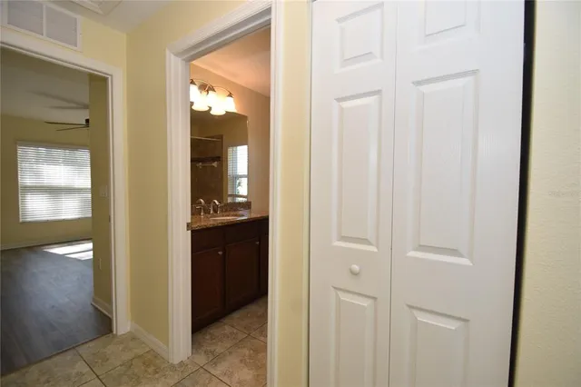 a bathroom with a granite countertop toilet sink and mirror