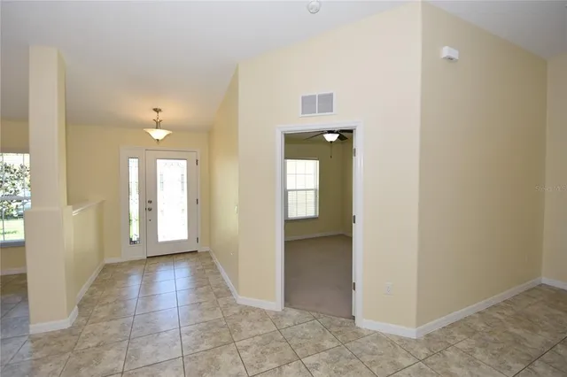 a view of a hallway with wooden shelves