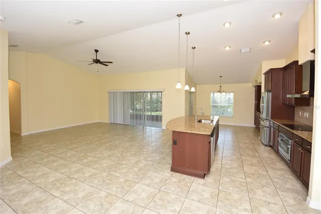 a large kitchen with stainless steel appliances kitchen island granite countertop a large counter top and oven