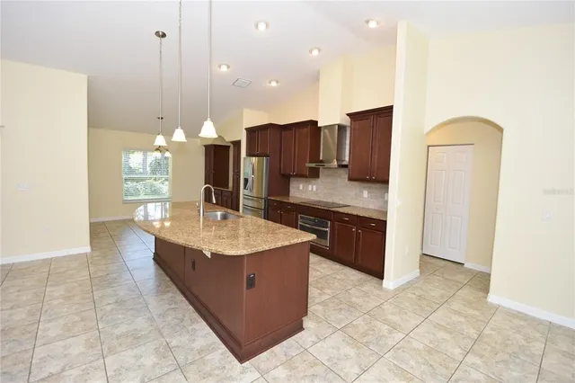 a bathroom with a granite countertop sink a mirror and a vanity