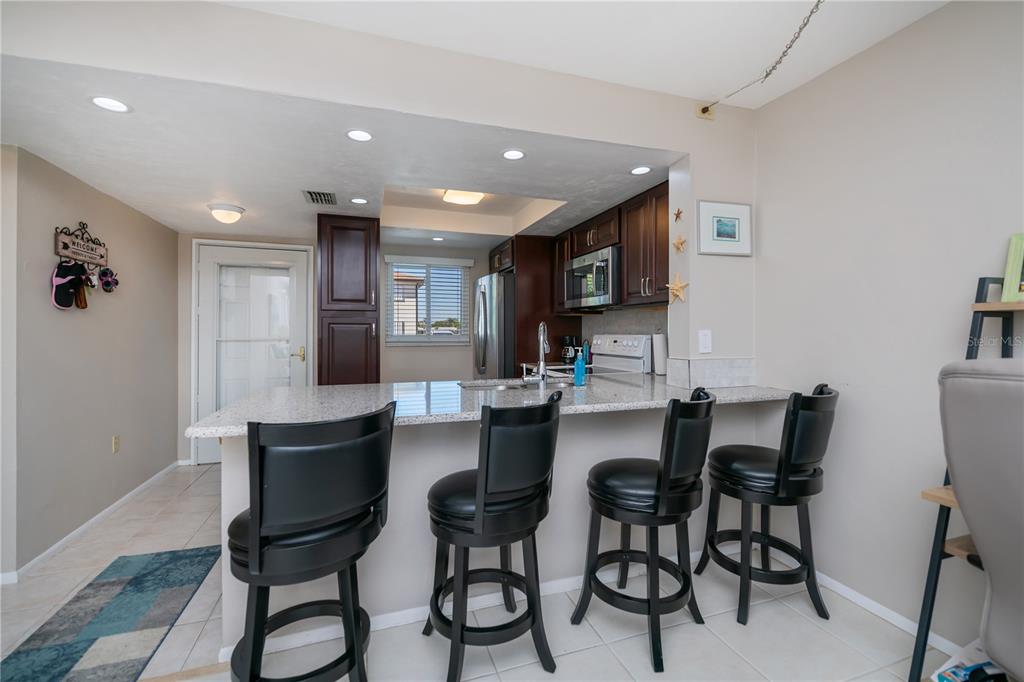 25275 Rampart Boulevard, Unit 1802 Punta Gorda, FL 33983 - Photo 12 of 41 a kitchen with a table and chairs in it