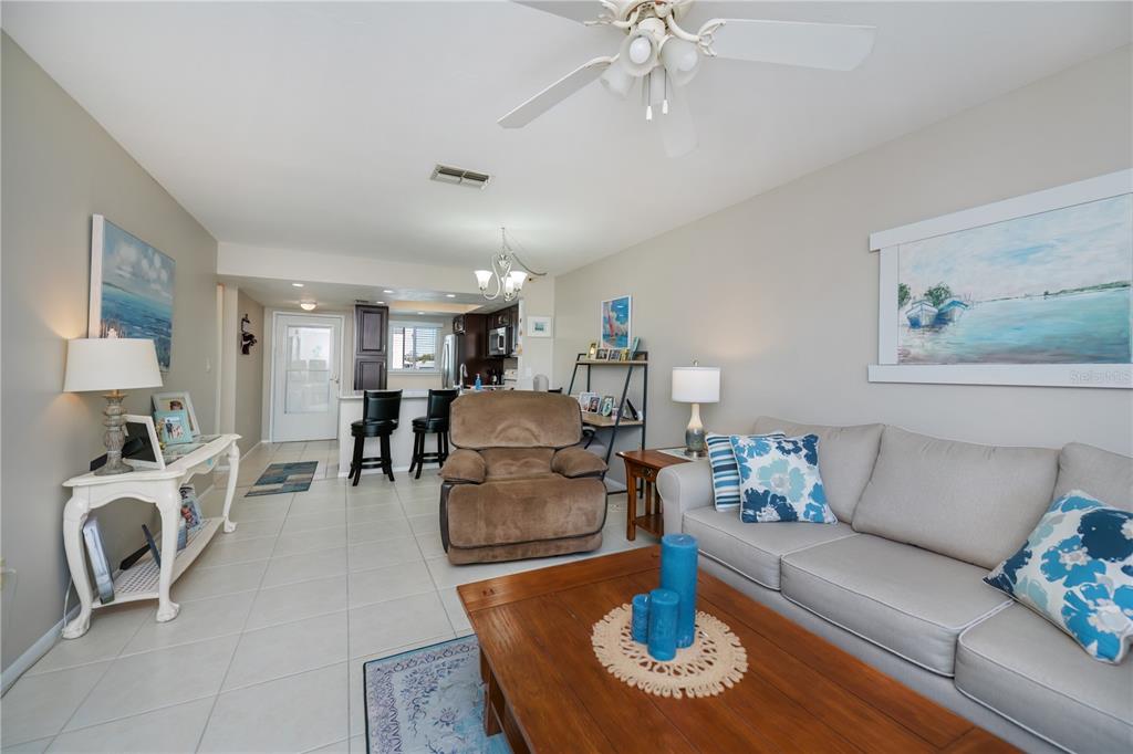 25275 Rampart Boulevard, Unit 1802 Punta Gorda, FL 33983 - Photo 21 of 41 a living room with furniture and a chandelier