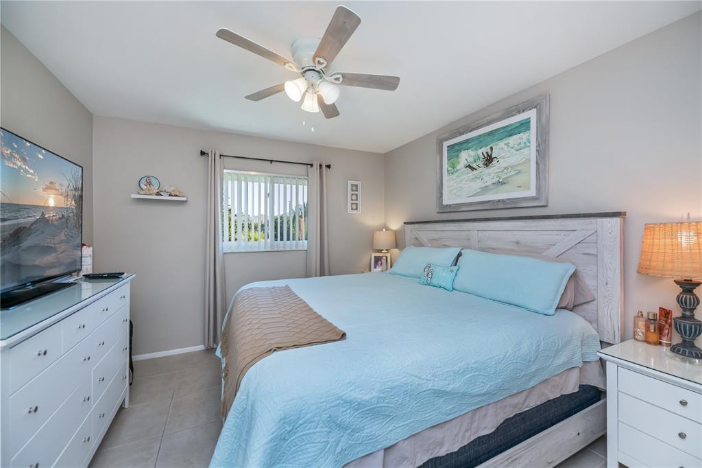 25275 Rampart Boulevard, Unit 1802 Punta Gorda, FL 33983 - Photo 23 of 41 a bedroom with a large bed and a flat screen tv