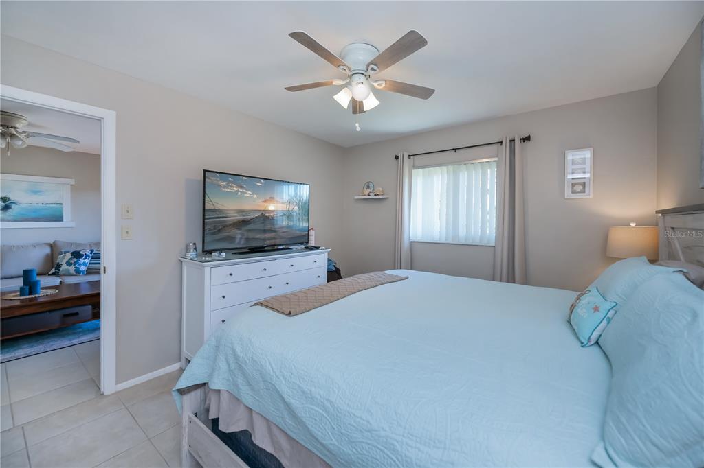 25275 Rampart Boulevard, Unit 1802 Punta Gorda, FL 33983 - Photo 24 of 41 a bedroom with a bed and a flat screen tv