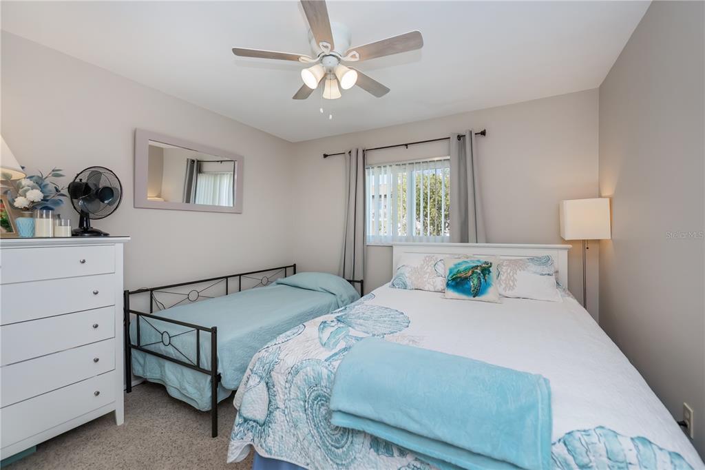 25275 Rampart Boulevard, Unit 1802 Punta Gorda, FL 33983 - Photo 27 of 41 a bedroom with a bed and a chandelier
