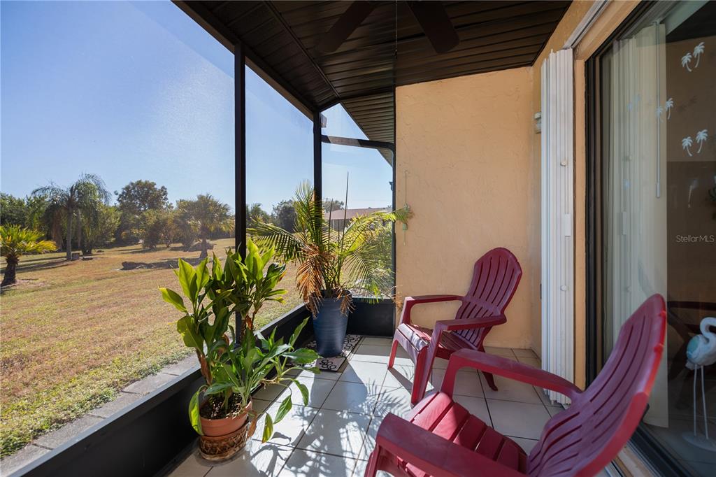 25275 Rampart Boulevard, Unit 1802 Punta Gorda, FL 33983 - Photo 32 of 41 a view of a porch with chairs and potted plants