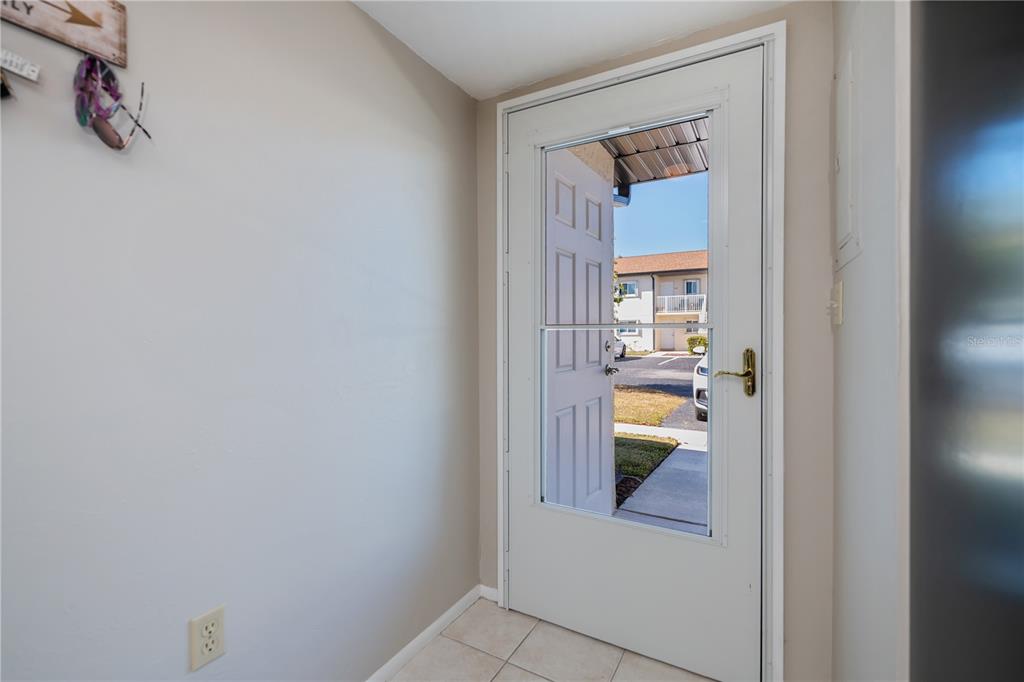 25275 Rampart Boulevard, Unit 1802 Punta Gorda, FL 33983 - Photo 8 of 41 a view of a hallway view of kitchen and dining room