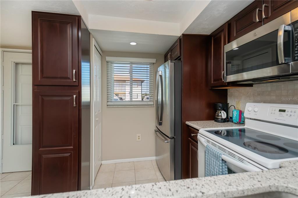 25275 Rampart Boulevard, Unit 1802 Punta Gorda, FL 33983 - Photo 10 of 41 a kitchen with a refrigerator stove and sink