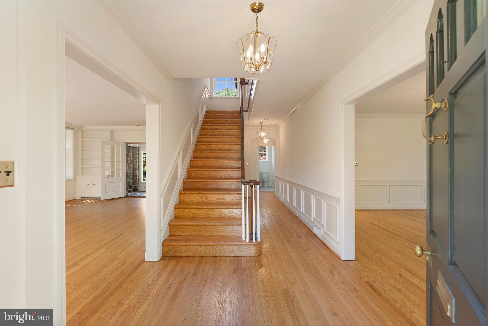 602 Stoneleigh Road Baltimore, MD 21212 - Photo 4 of 31 a view of a hallway with wooden floor and staircase