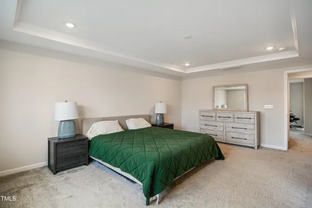 a bedroom with a bed and dresser