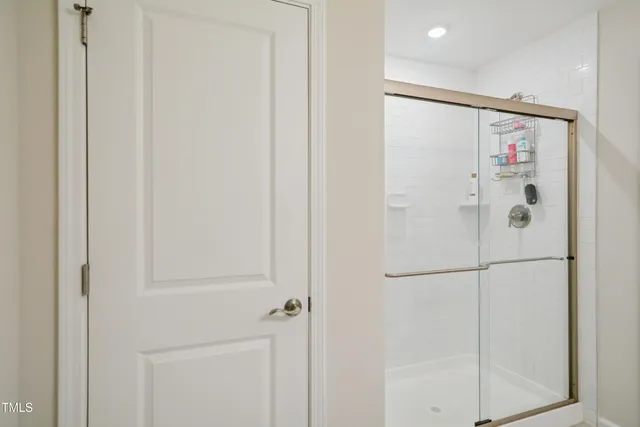 a bathroom with a shower and a glass door