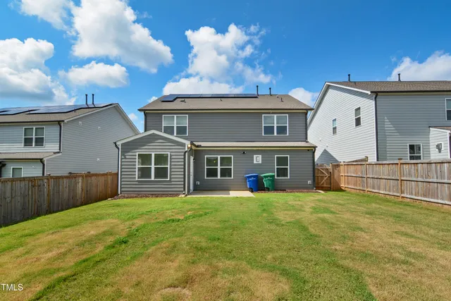 a view of a house with a yard and sitting area