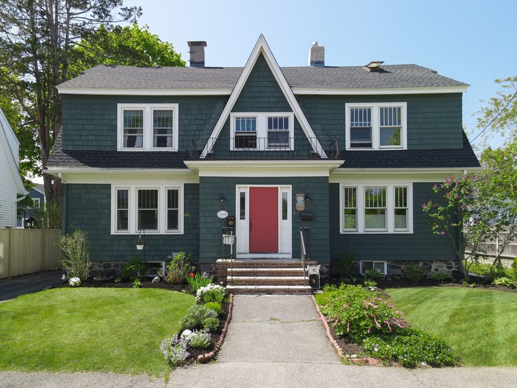 a front view of a house with garden