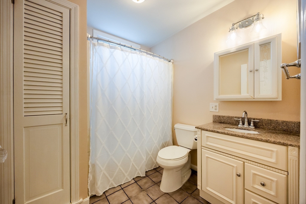 14 Merrill Road Marblehead, MA 01945 - Photo 14 of 29 a bathroom with a granite countertop sink toilet and shower