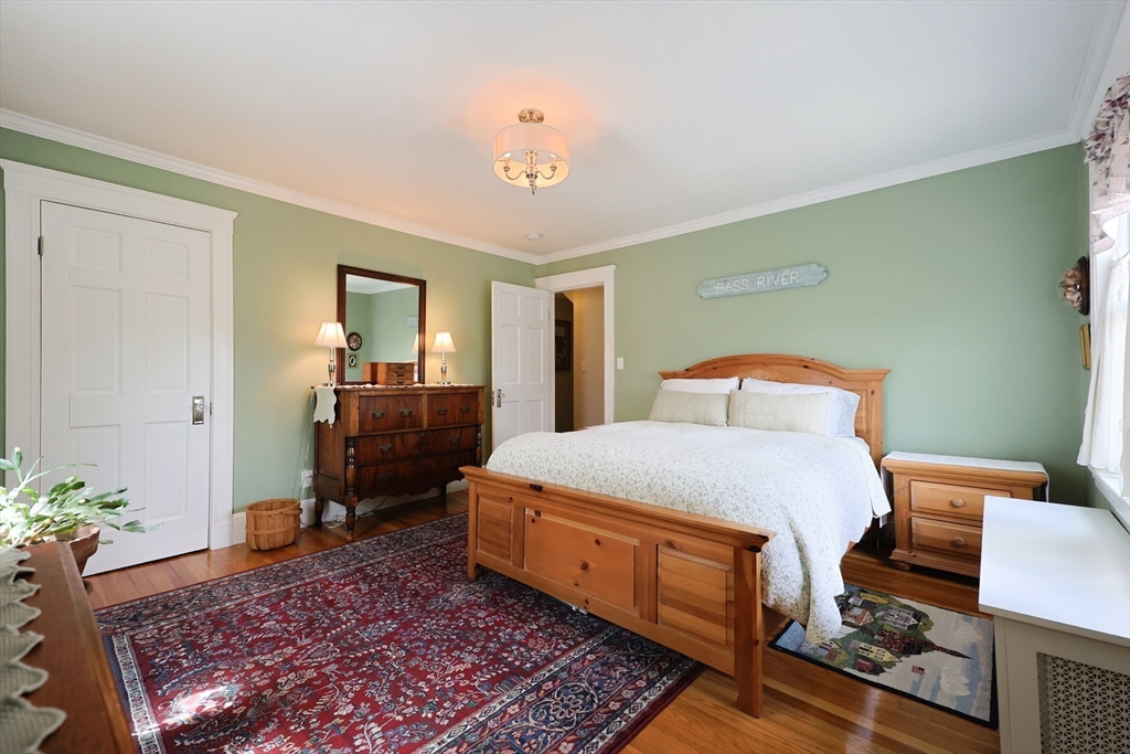 14 Merrill Road Marblehead, MA 01945 - Photo 16 of 29 a bedroom with a bed and a table in it