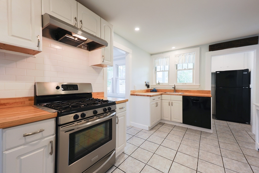 14 Merrill Road Marblehead, MA 01945 - Photo 10 of 29 a kitchen with a stove a sink and a refrigerator