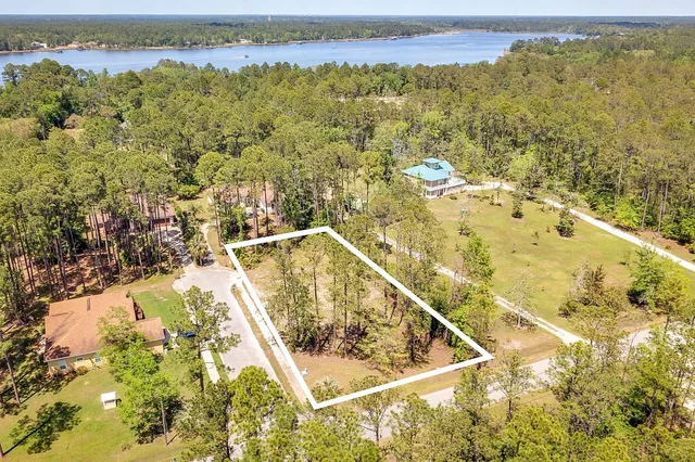 an aerial view of a house with a lake view