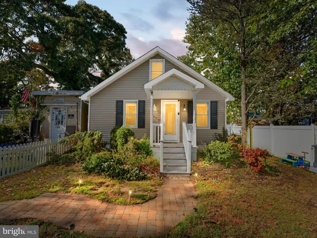 a front view of house with yard and trees around
