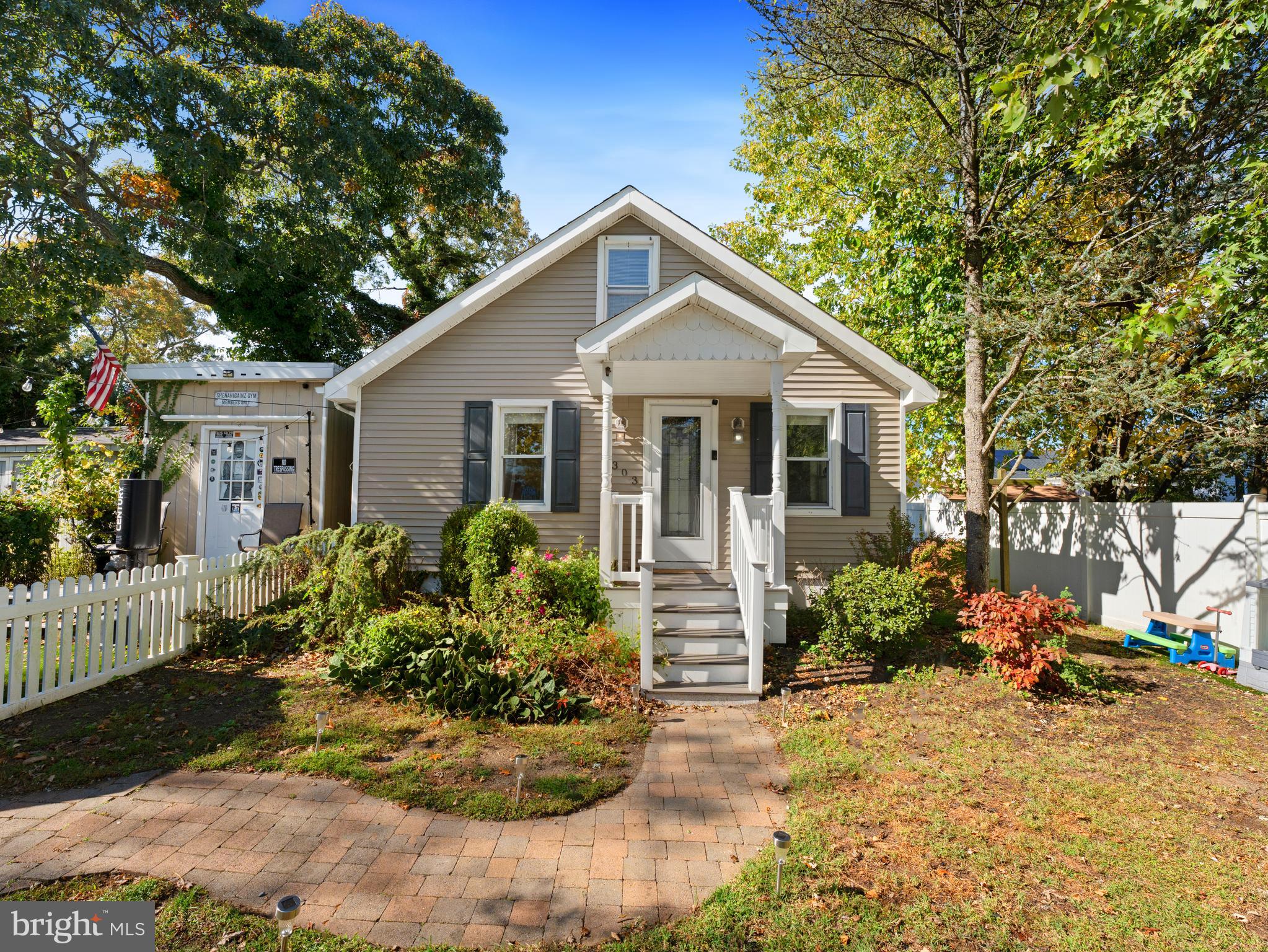 303 Garden Terrace Somers Point, NJ 08244 - Photo 2 of 38 a front view of a house with a yard and potted plants