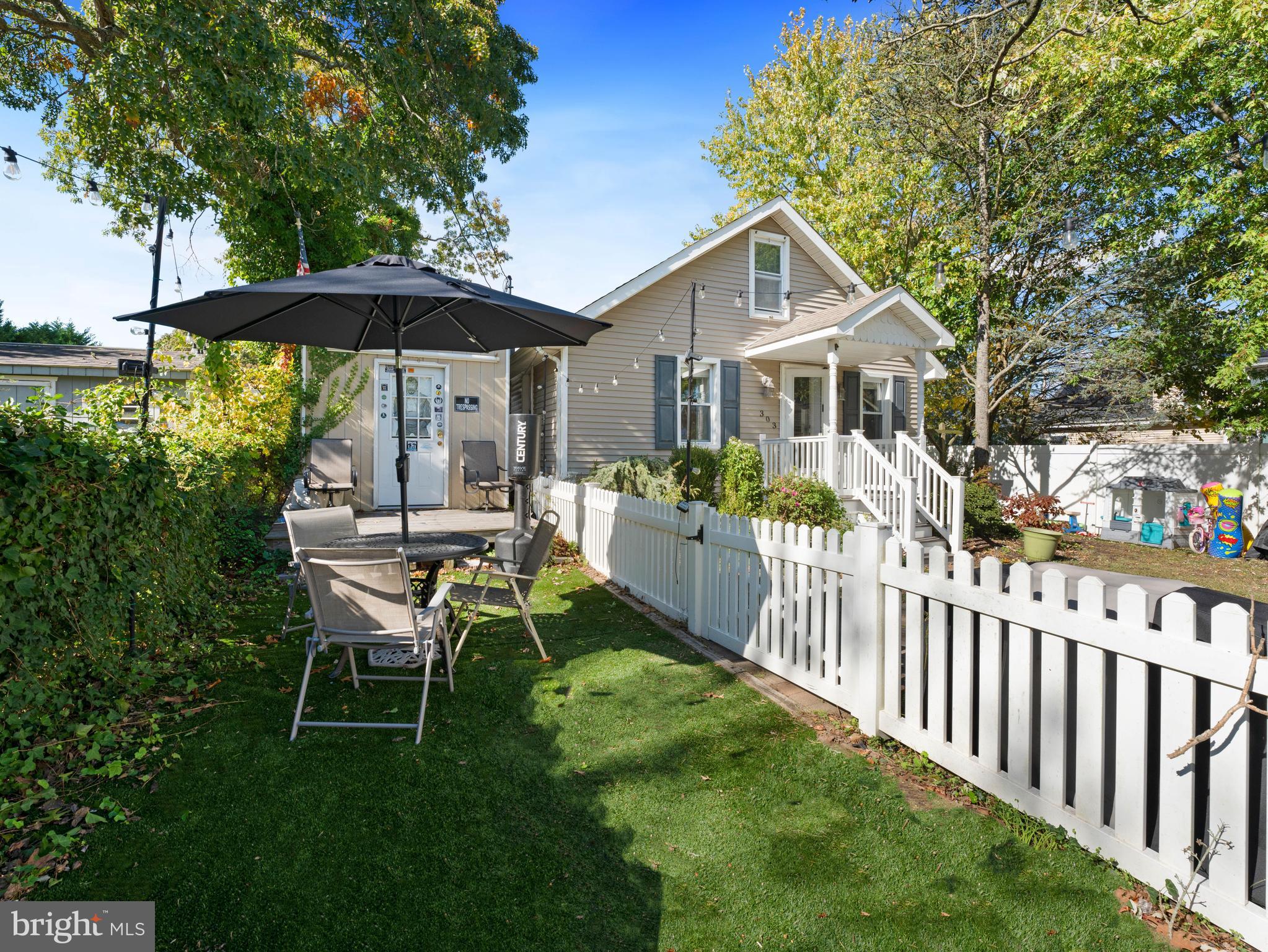 303 Garden Terrace Somers Point, NJ 08244 - Photo 24 of 38 a view of a house with a yard table and chairs