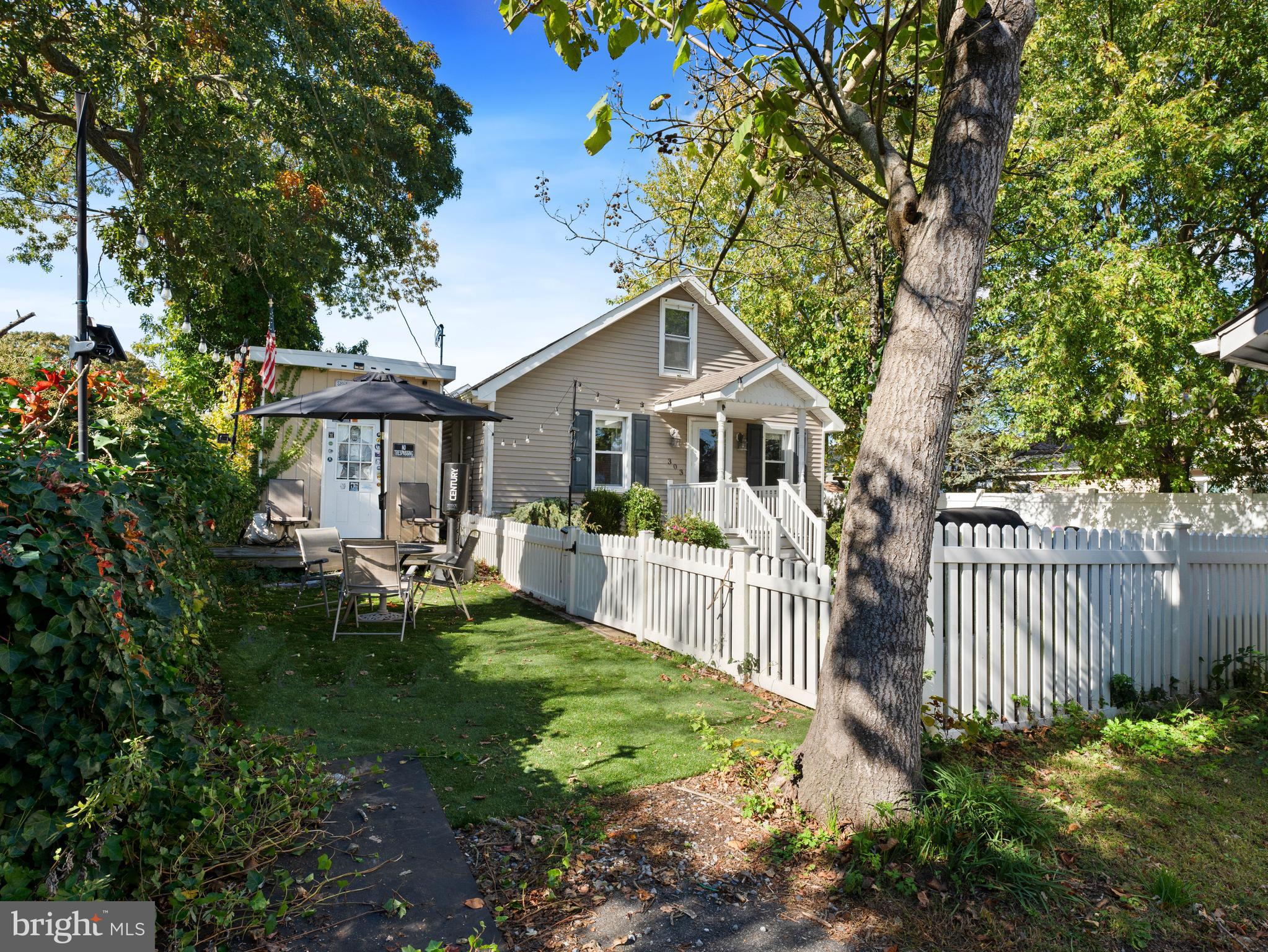 303 Garden Terrace Somers Point, NJ 08244 - Photo 25 of 38 a front view of a house with a yard table and chairs