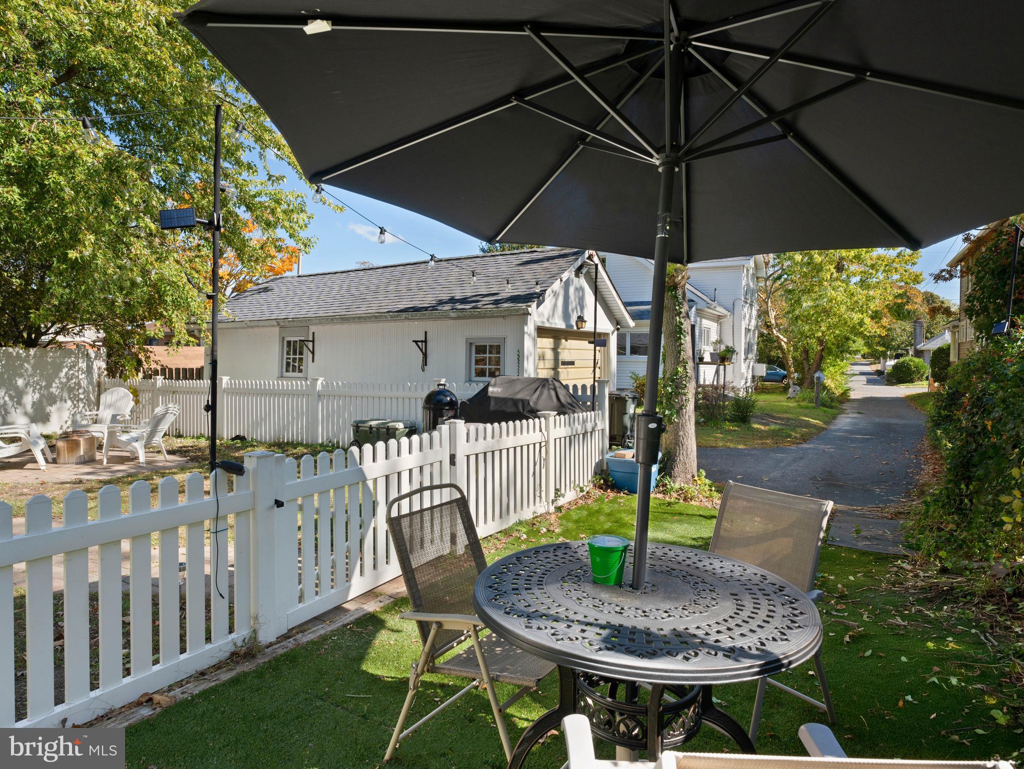 303 Garden Terrace Somers Point, NJ 08244 - Photo 26 of 38 a patio table with chairs and a umbrella