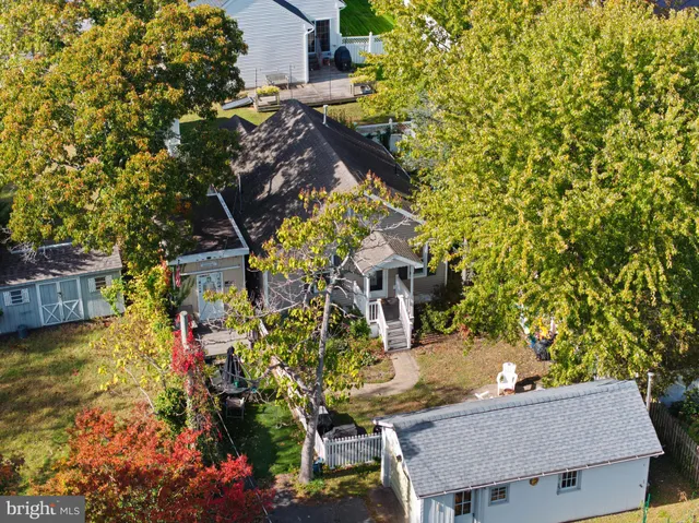 a backyard of a house with table and chairs and potted plants