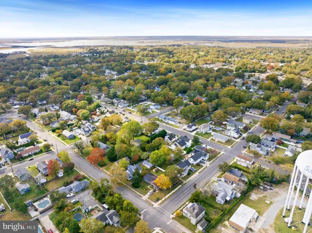 an aerial view of residential building with green space