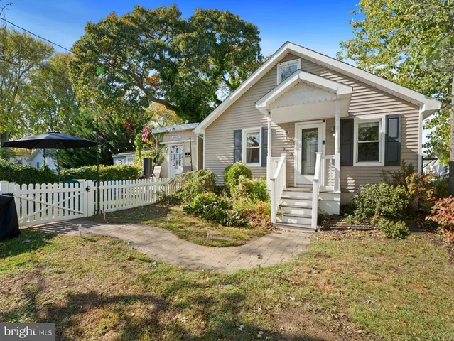 a view of a house with a yard and garden