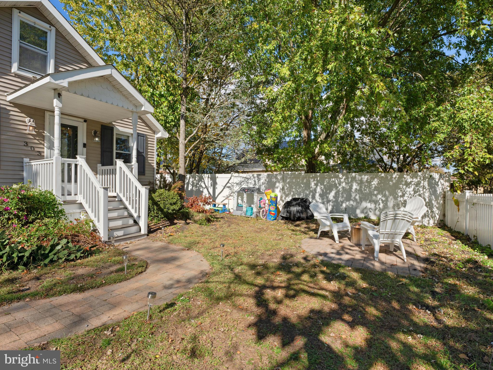 303 Garden Terrace Somers Point, NJ 08244 - Photo 4 of 38 a view of a patio with table and chairs and potted plants