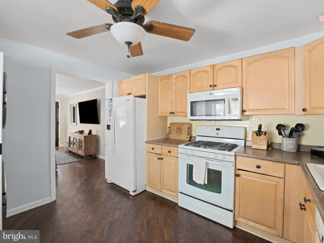 a view of a kitchen with a stove cabinets and a ceiling fan