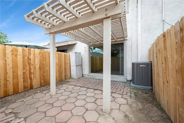 a view of a hallway with wooden door and stairs