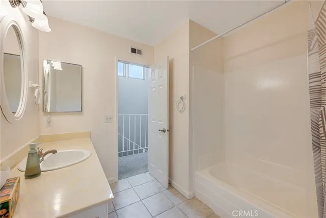 a bathroom with a sink a vanity and shower