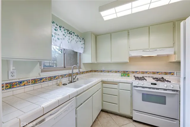 a kitchen with a sink stove and cabinets