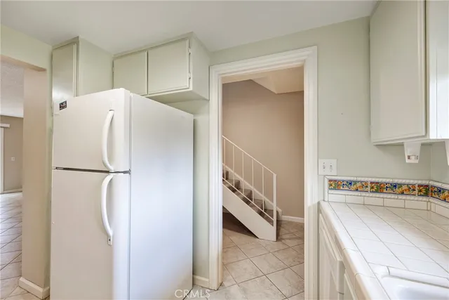 a white refrigerator freezer sitting in a kitchen