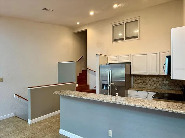a kitchen with a sink and wooden cabinets