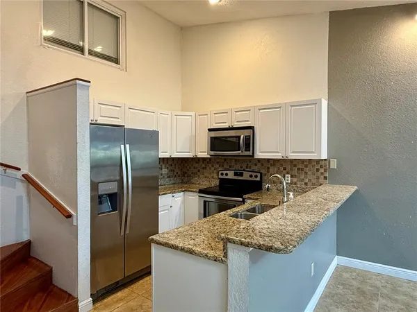 a kitchen with a sink stove and refrigerator