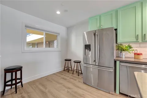 a kitchen with stainless steel appliances a refrigerator and a stove top oven