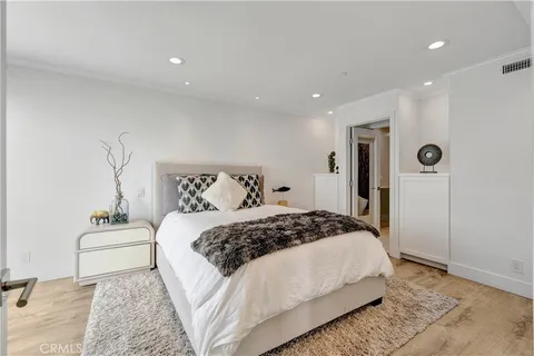 a bedroom with a large bed and a couch