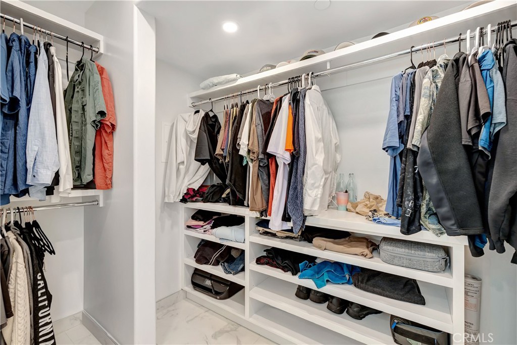 1 3rd Place, Unit 302 Long Beach, CA 90802 - Photo 24 of 51 a view of walk in closet with clothes and shoes