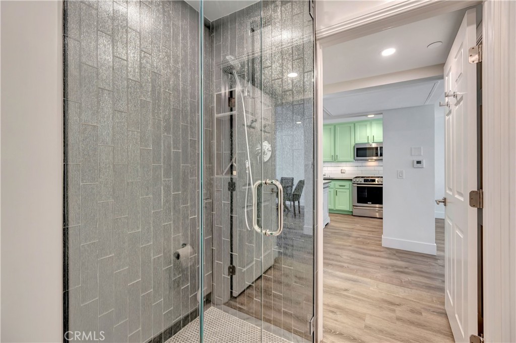 1 3rd Place, Unit 302 Long Beach, CA 90802 - Photo 26 of 51 a bathroom with a glass shower door and a sink