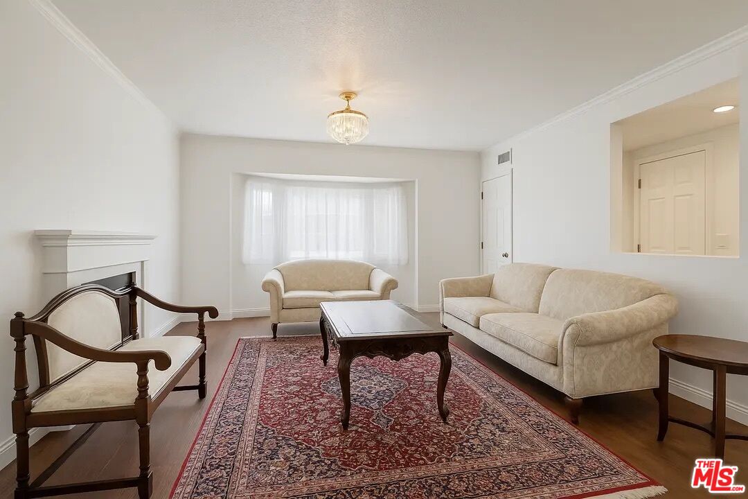 21620 Burbank Boulevard, Unit 9 Woodland Hills, CA 91367 - Photo 1 of 14 a living room with furniture and a rug