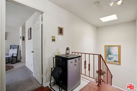 a view of a hallway with workspace and entryway