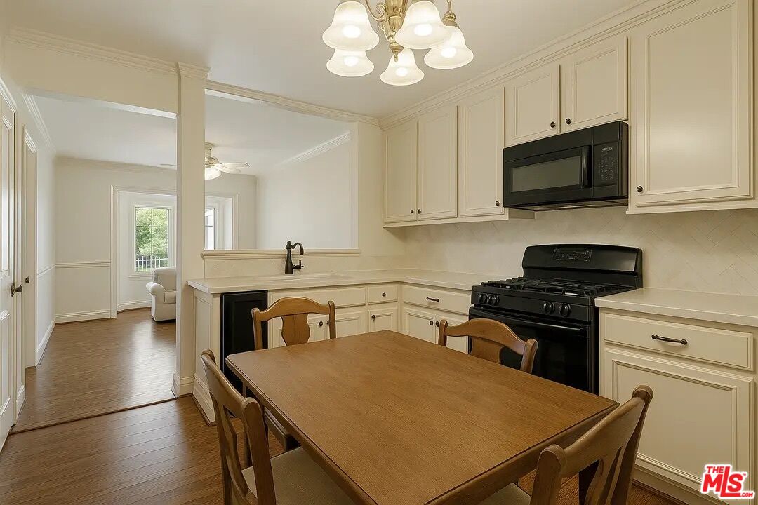 21620 Burbank Boulevard, Unit 9 Woodland Hills, CA 91367 - Photo 3 of 14 a kitchen with a stove a sink and a microwave