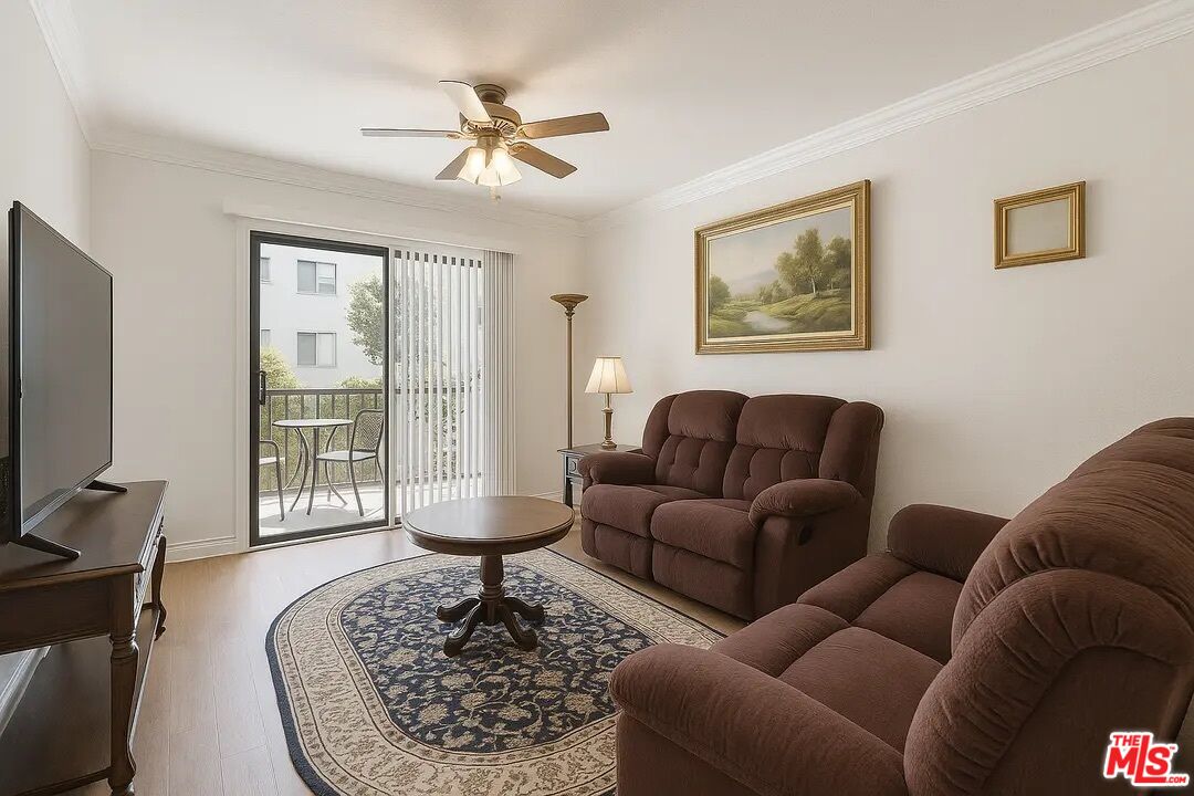 21620 Burbank Boulevard, Unit 9 Woodland Hills, CA 91367 - Photo 6 of 14 a living room with furniture a couch and a flat screen tv with wooden floor