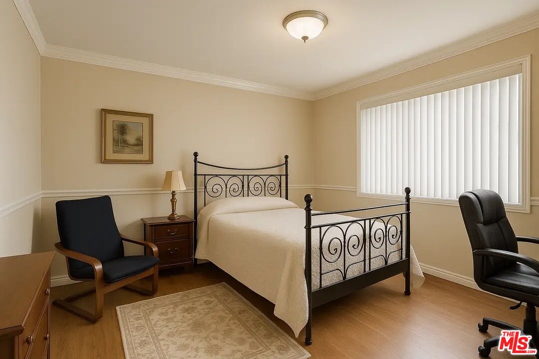 21620 Burbank Boulevard, Unit 9 Woodland Hills, CA 91367 - Photo 7 of 14 a bedroom with a bed and a chair