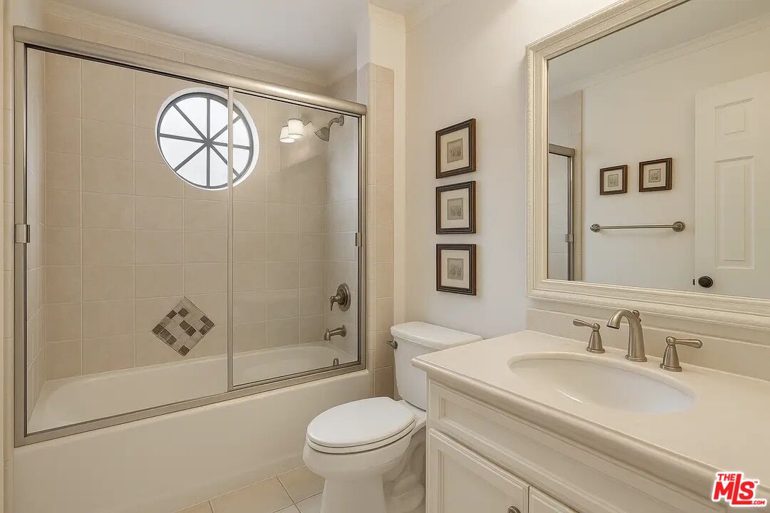 21620 Burbank Boulevard, Unit 9 Woodland Hills, CA 91367 - Photo 10 of 14 a bathroom with a sink a toilet and a mirror