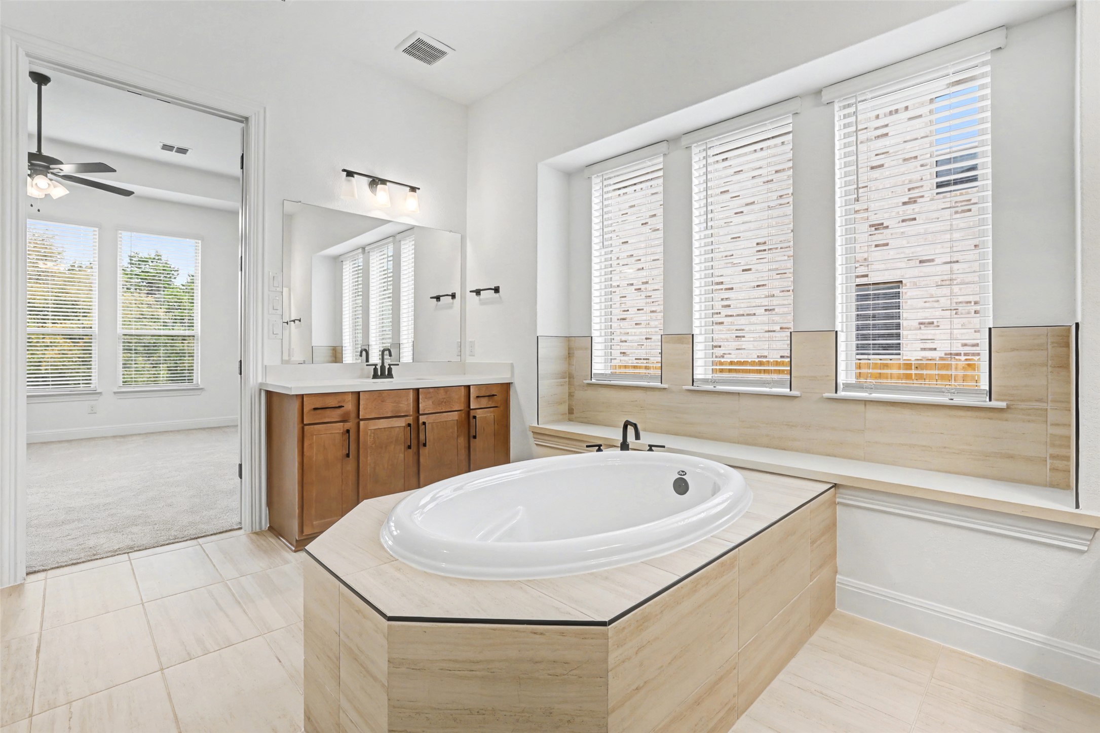 104 Rocky River Road Georgetown, TX 78628 - Photo 21 of 39 a bathroom with a tub sink and mirror